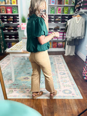 Hunter green puff-sleeve blouse with half-zip closure and gathered shoulder detail
