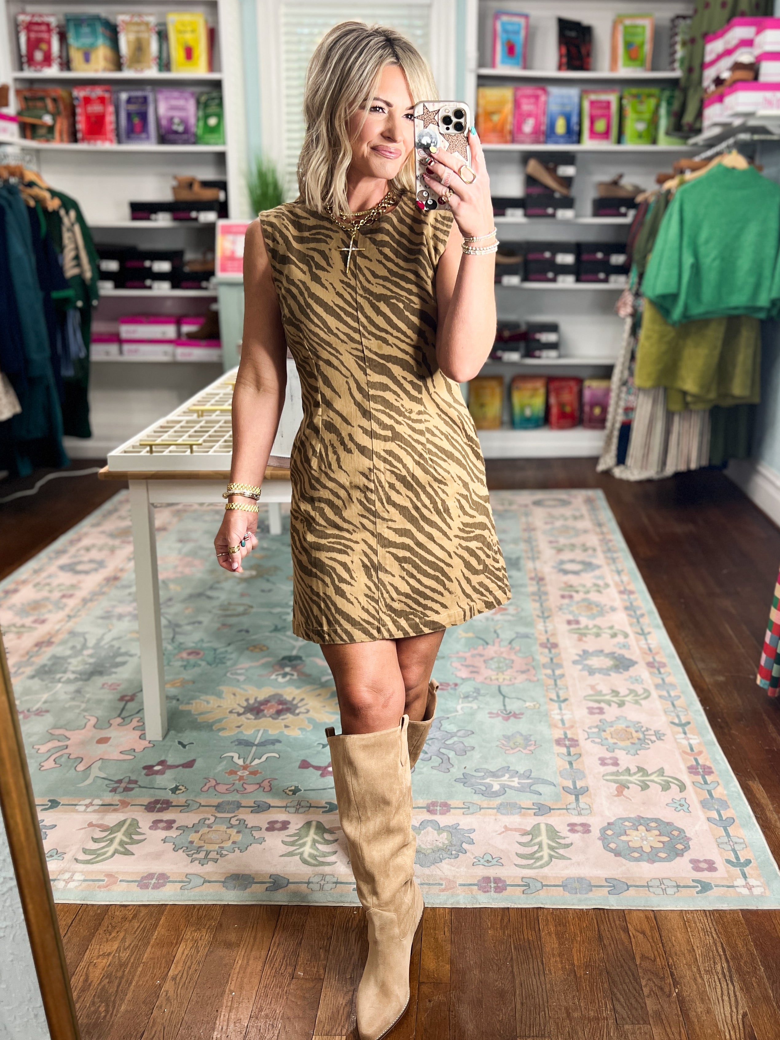 Sleeveless brown tiger-print mini dress shown from the front.