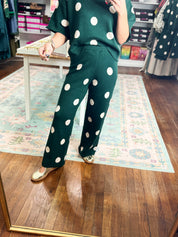 Hunter green polka-dot knit pants with wide hems and ankle-length fit