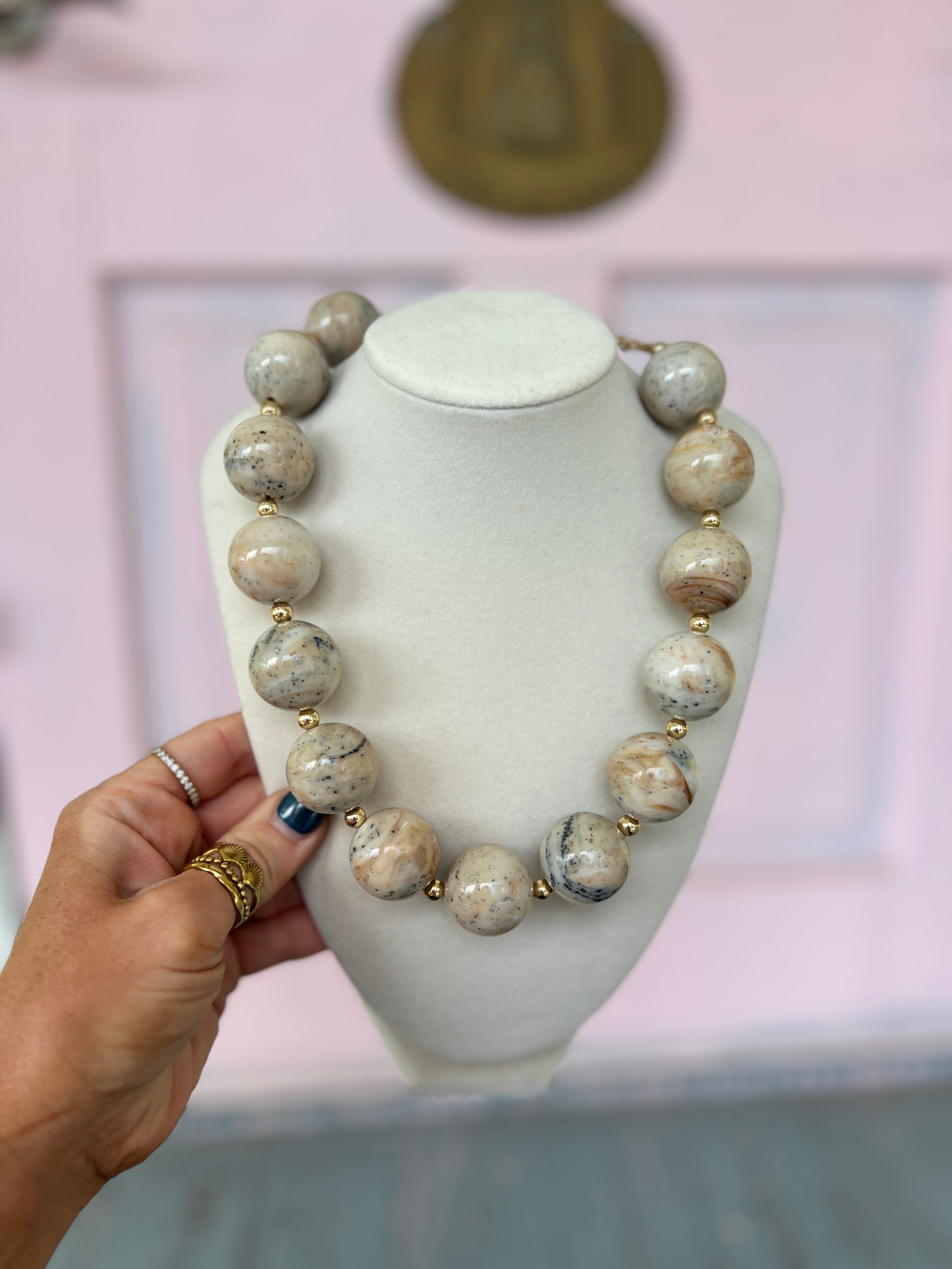 Beige marble acrylic bead necklace with gold-toned spacer accents