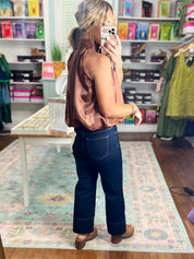 Brown sleeveless satin top shown from back, draped high neckline and gathers