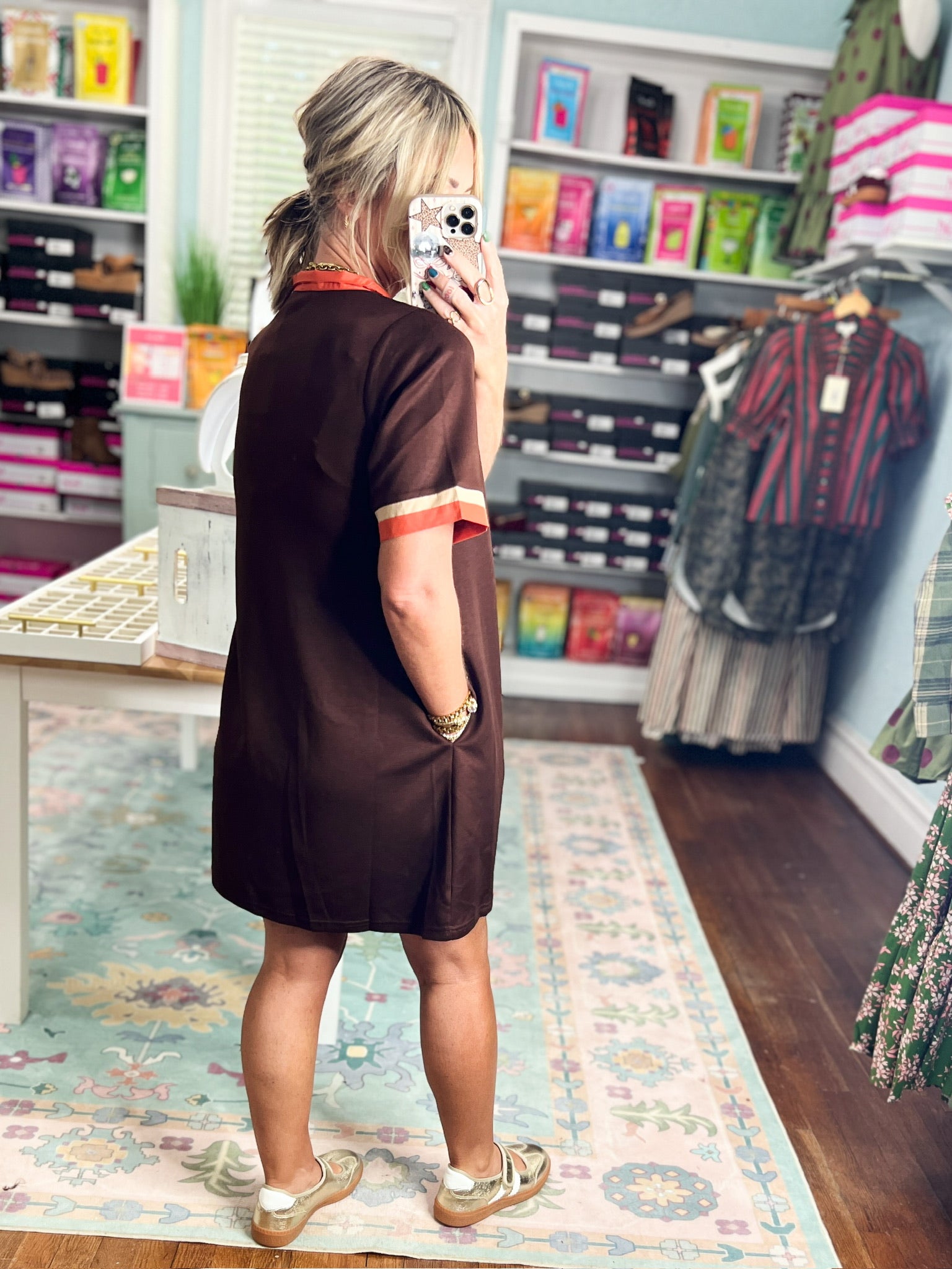 Brown casual dress back view with orange sleeve trim and V-shaped collar seam