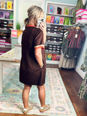 Brown casual dress back view with orange sleeve trim and V-shaped collar seam