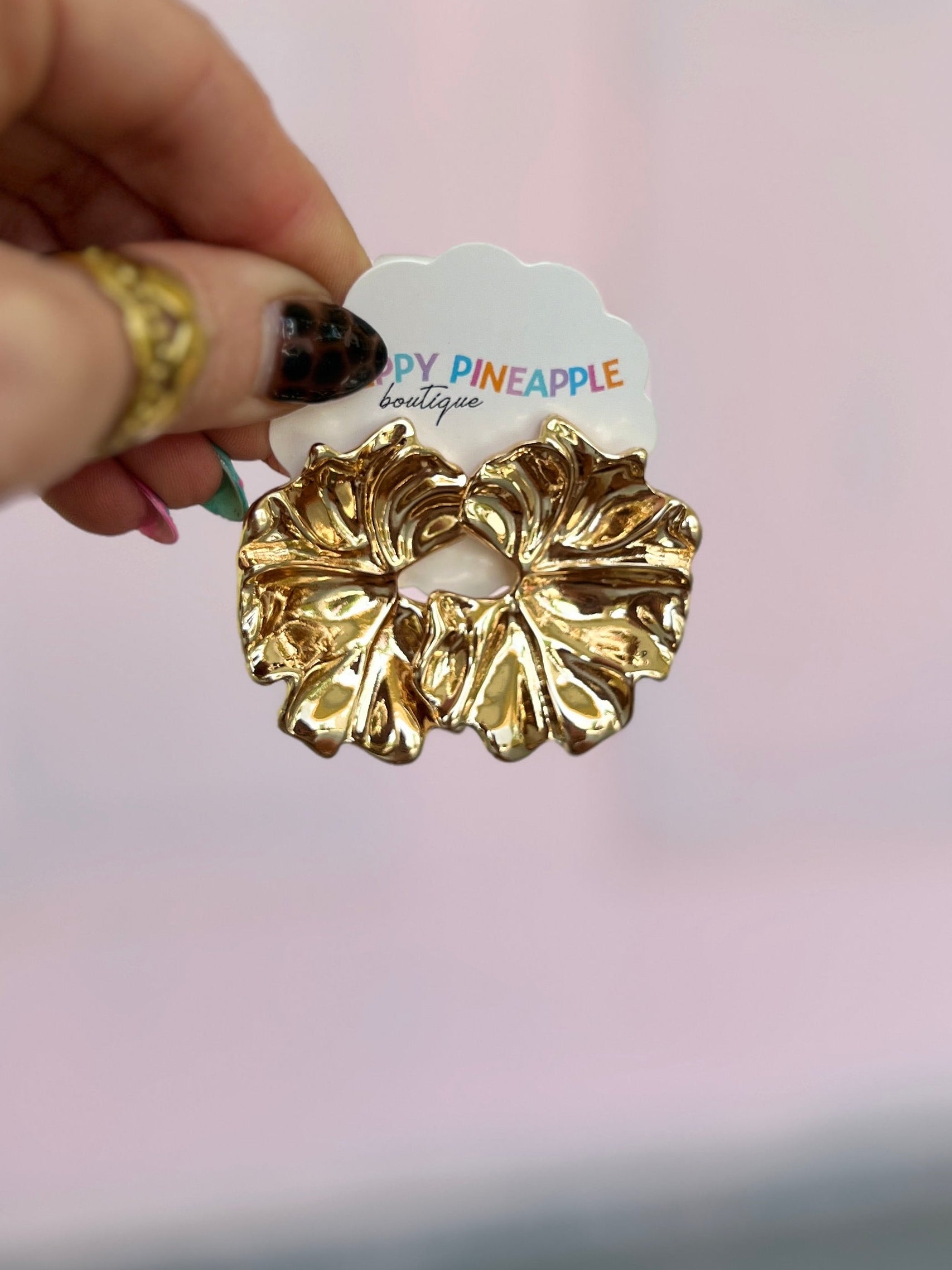 Gold-tone metal leaf drop earrings with dark center detail