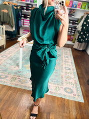 Teal sleeveless midi dress with twisted waist tie and fitted skirt.