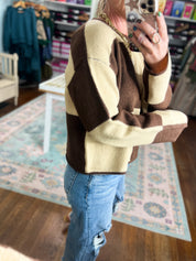 Color-block crew neck sweater in dark brown and cream, long sleeves (close-up)