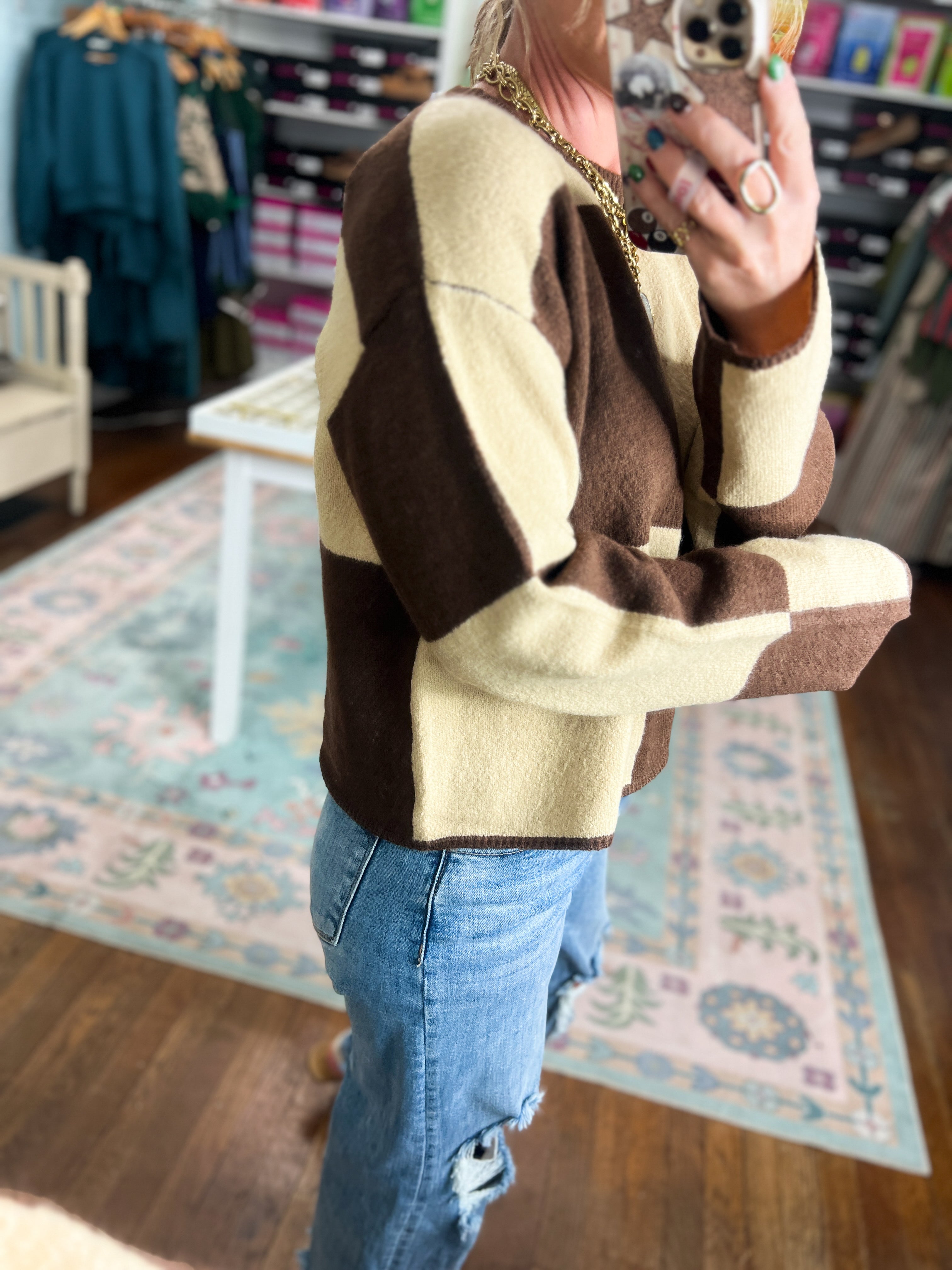 Color-block crew neck sweater in dark brown and cream, long sleeves (close-up)