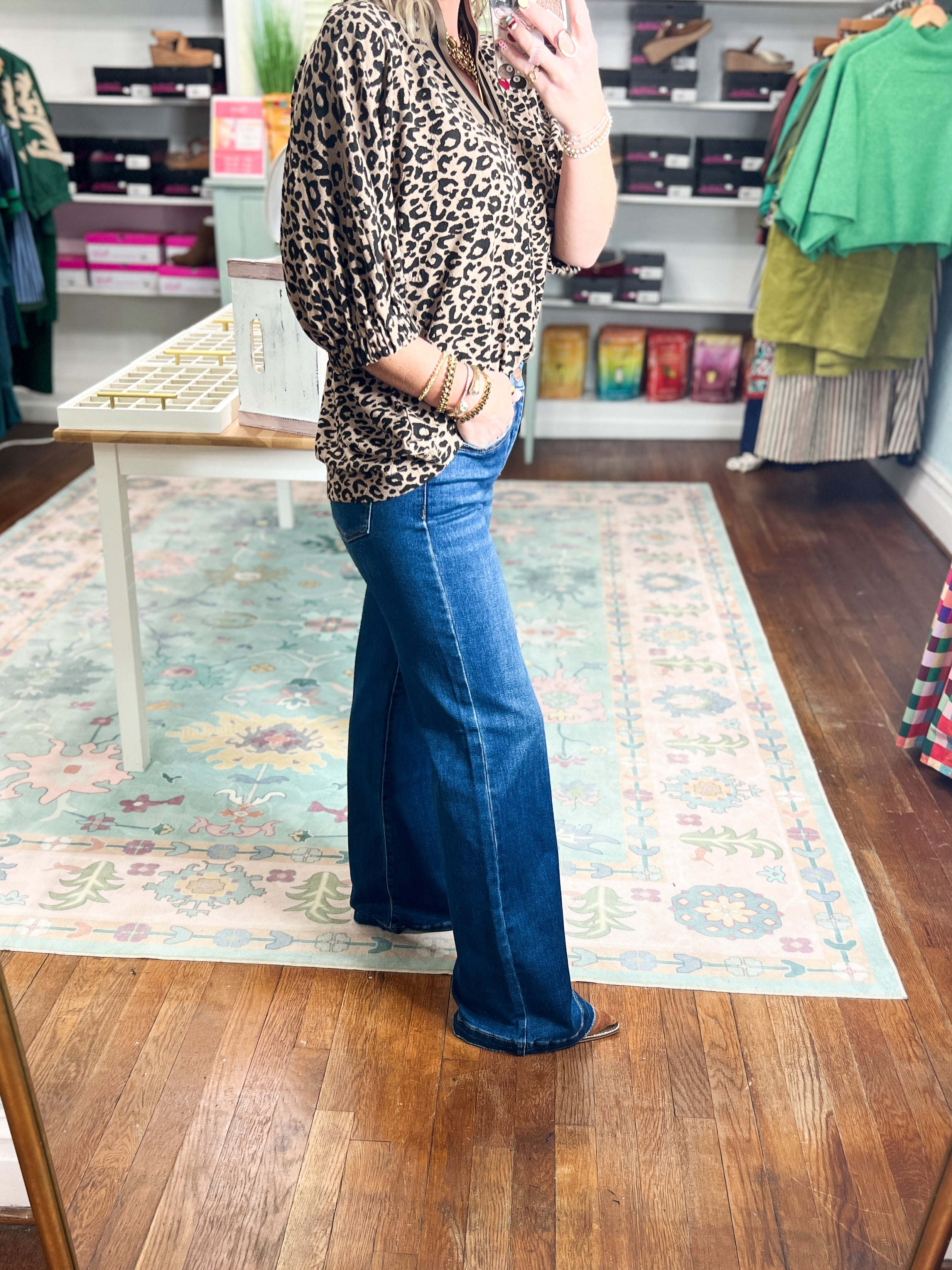 Women's high-rise wide-leg jeans with adjustable waist, blue denim; side profile.