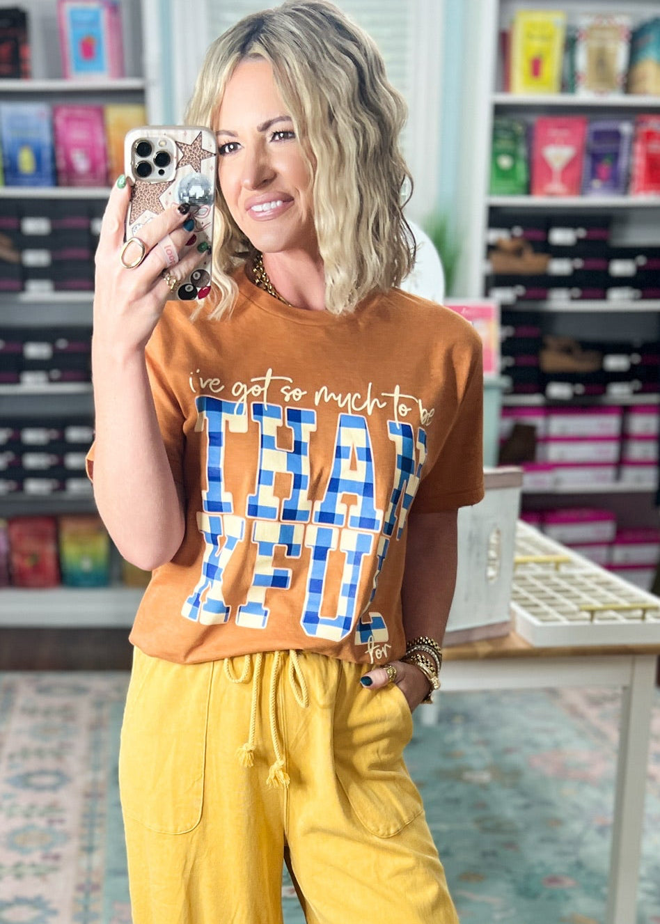Orange short-sleeve graphic T-shirt with crew neck and blue printed lettering