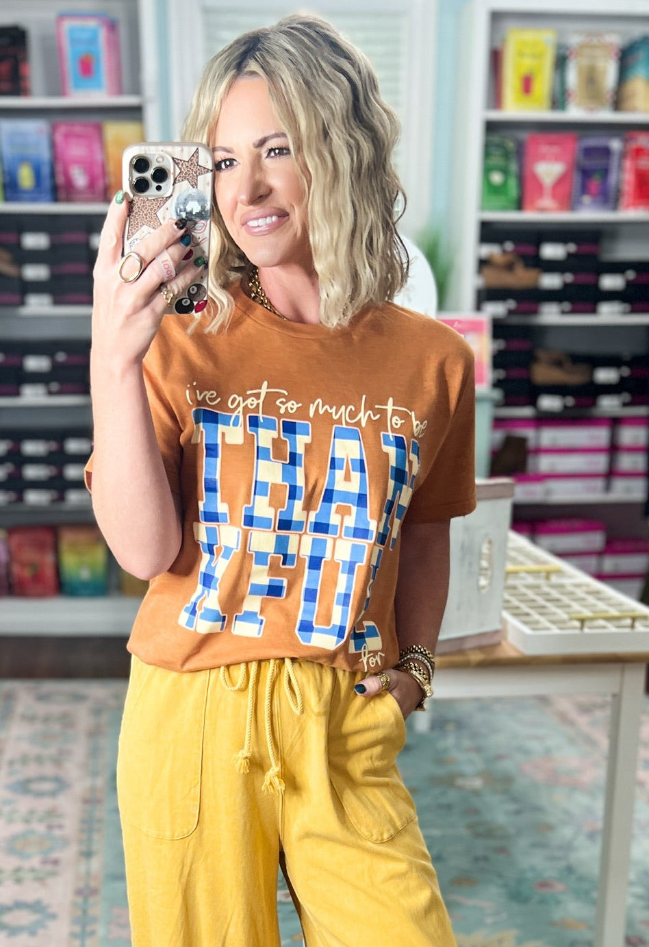 Orange short-sleeve graphic T-shirt with crew neck and blue printed lettering