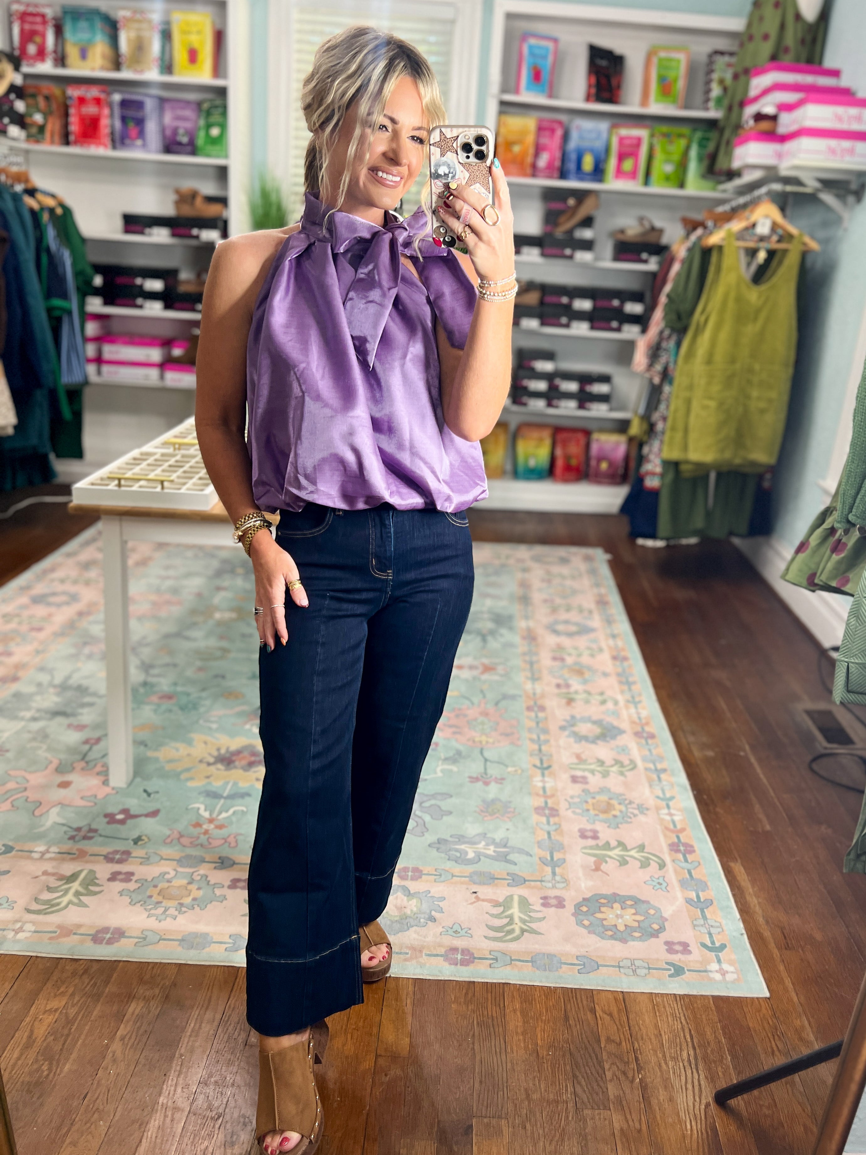 Purple sleeveless balloon top with ruffle neckline and loose draped body