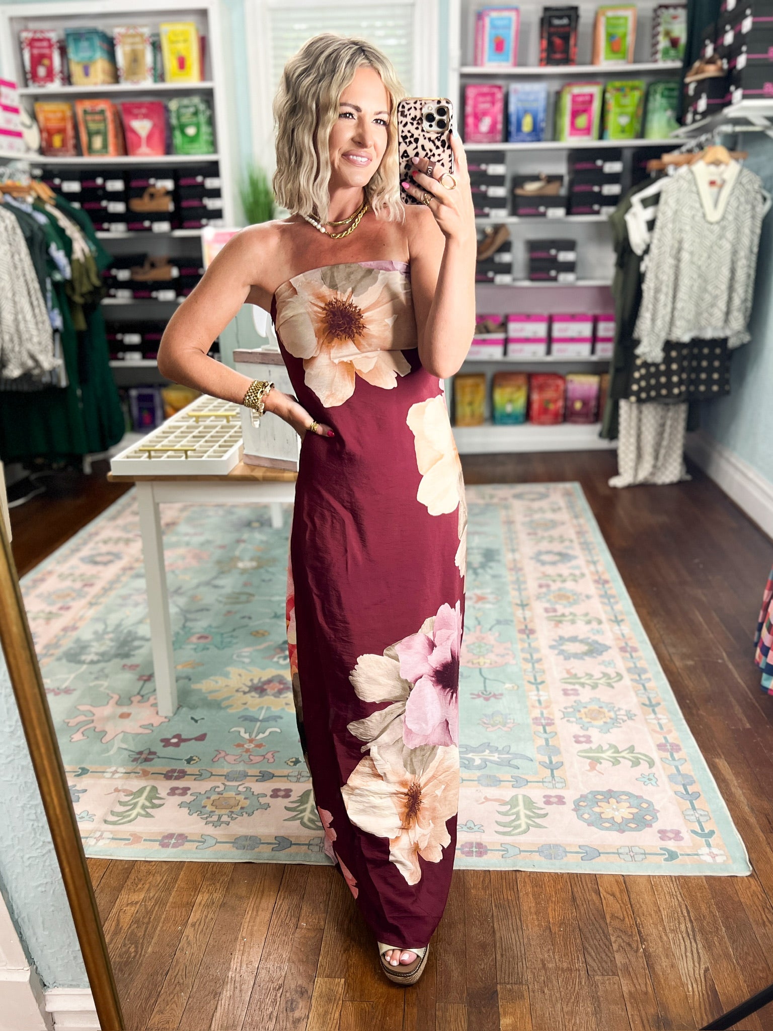 Burgundy strapless maxi dress featuring oversized cream and pink floral print, slim silhouette