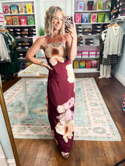 Burgundy strapless maxi dress featuring oversized cream and pink floral print, slim silhouette