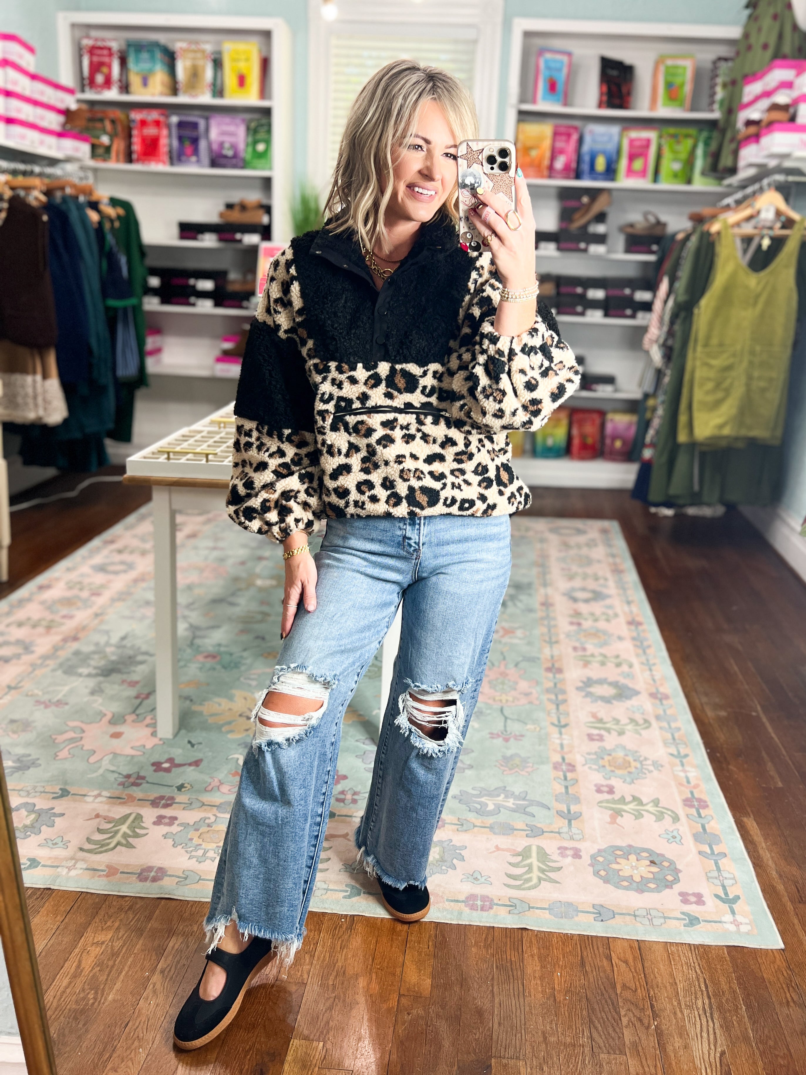 Leopard-print fleece pullover with dark collar, long sleeves and button placket