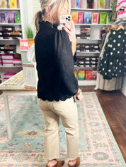 Black faux suede tunic top with mock neck and long sleeves, scalloped hemline