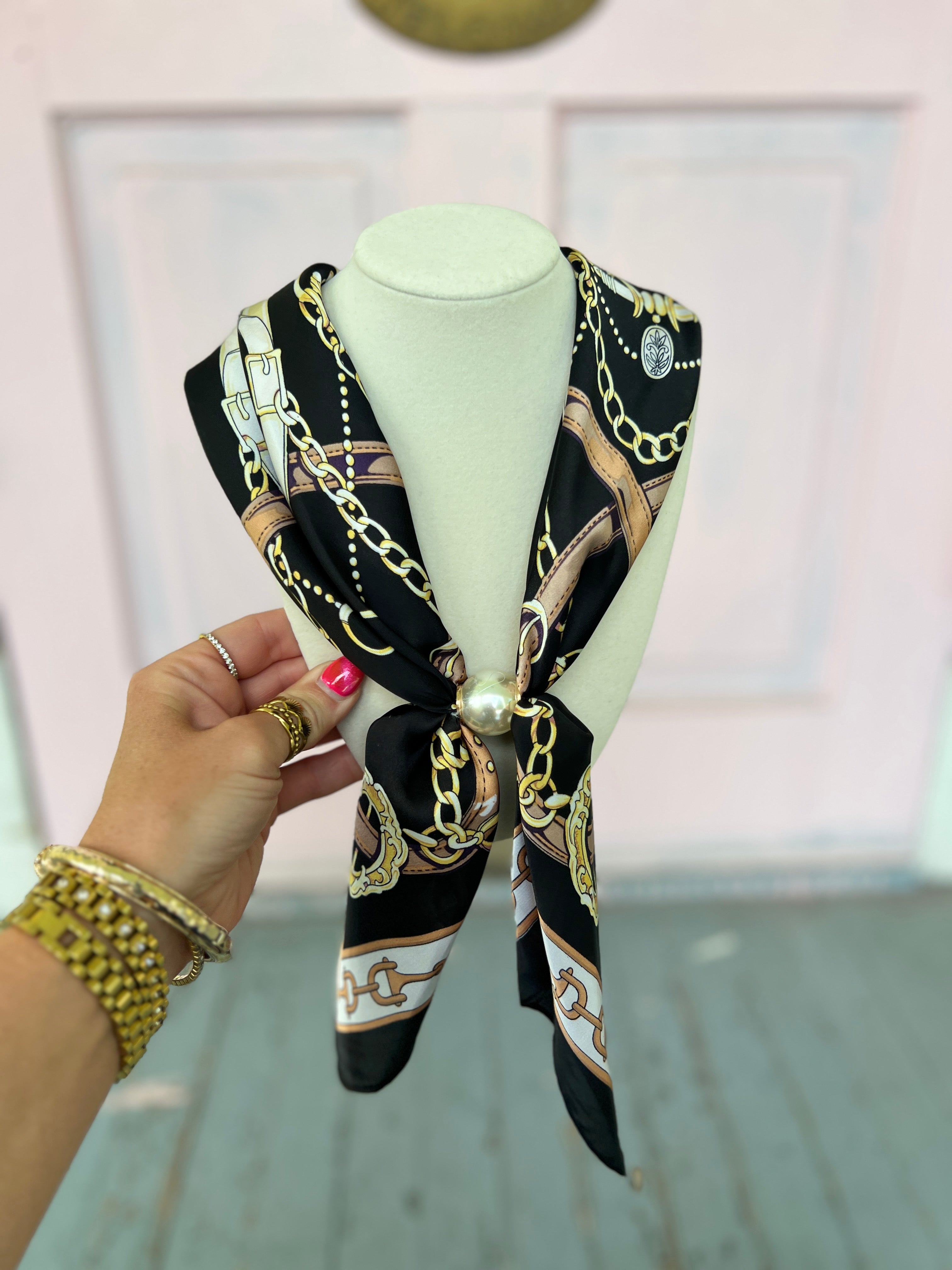 Black scarf necklace with gold chain links and circular hardware detail
