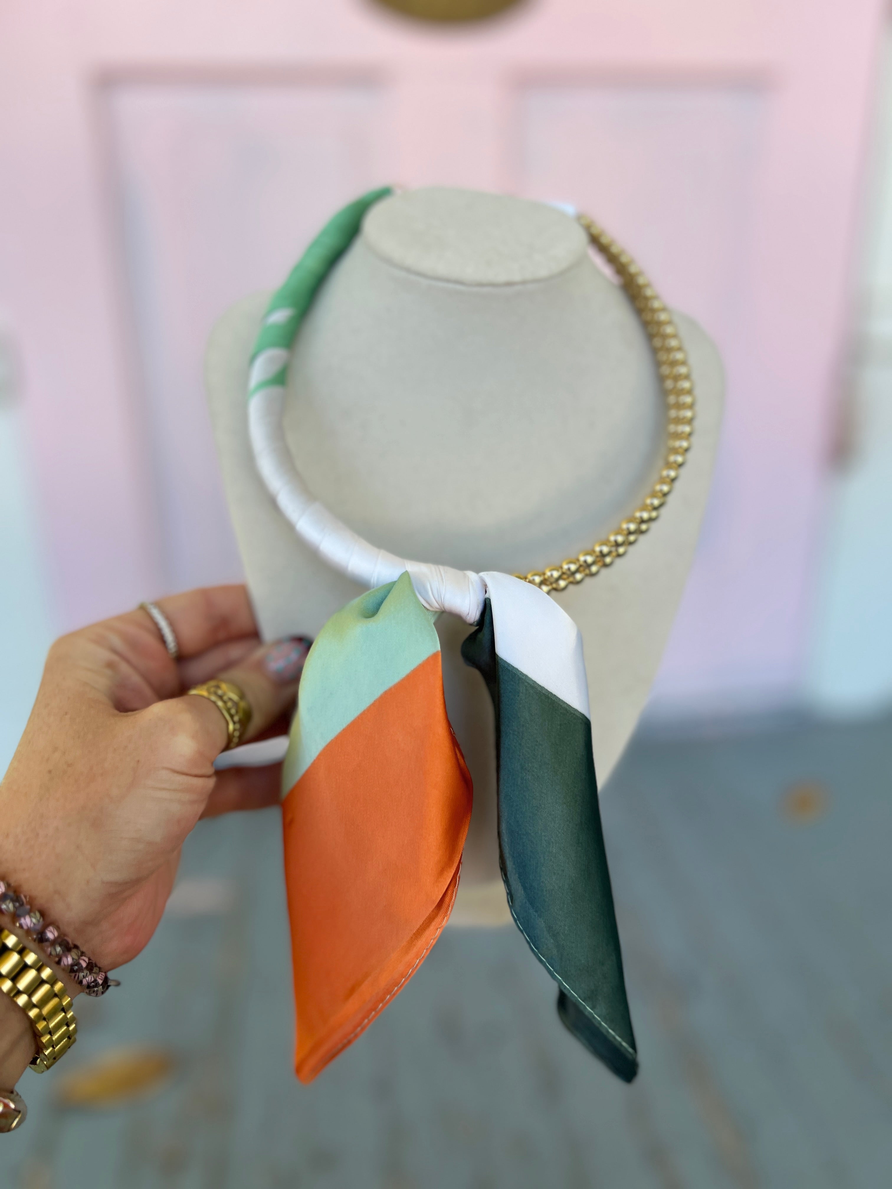 Scarf-wrapped collar necklace with mint, orange, and teal fabric and gold chain