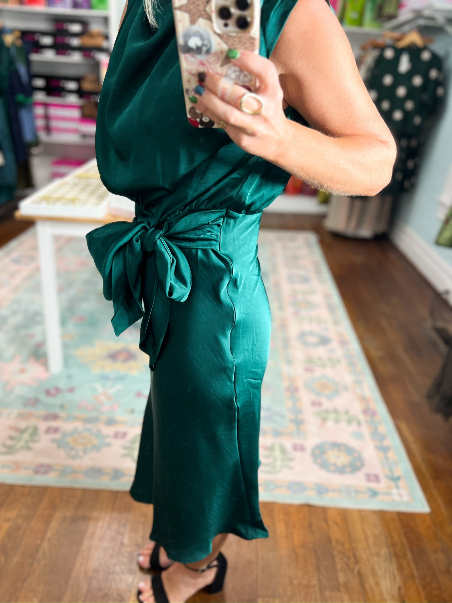 Teal midi dress showing ruched tied waist bow at the side seam.