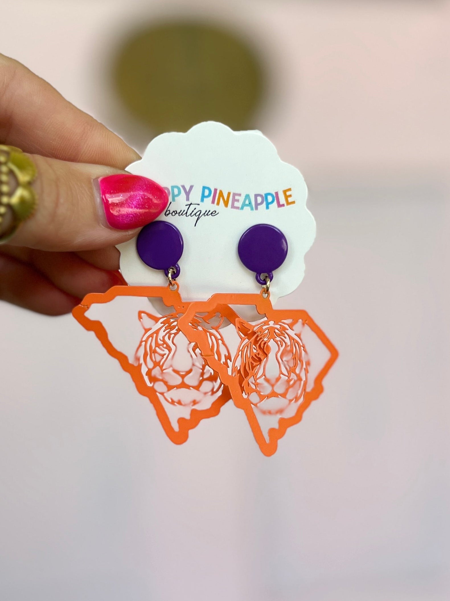 Dangling orange and purple state-map earrings with tiger logo silhouettes