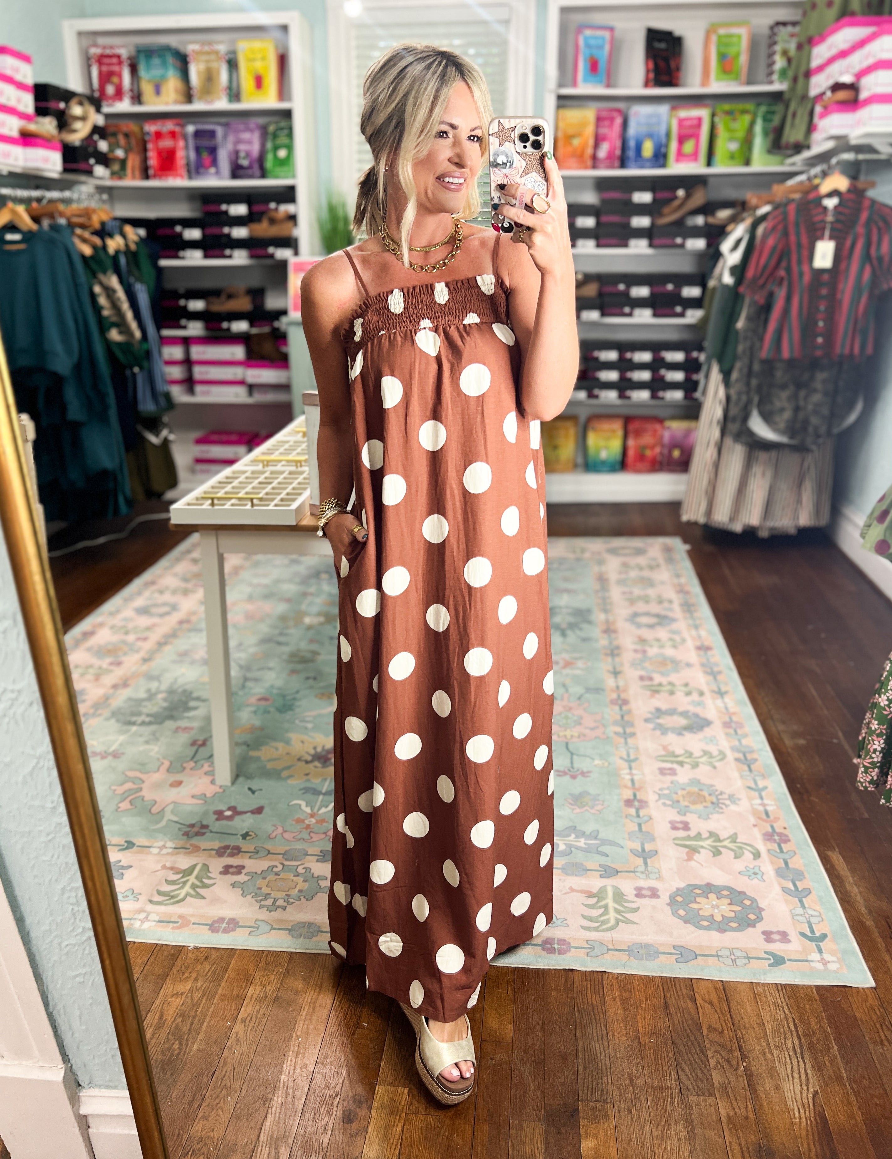 Brown polka-dot sleeveless maxi dress with scoop neckline and full length skirt
