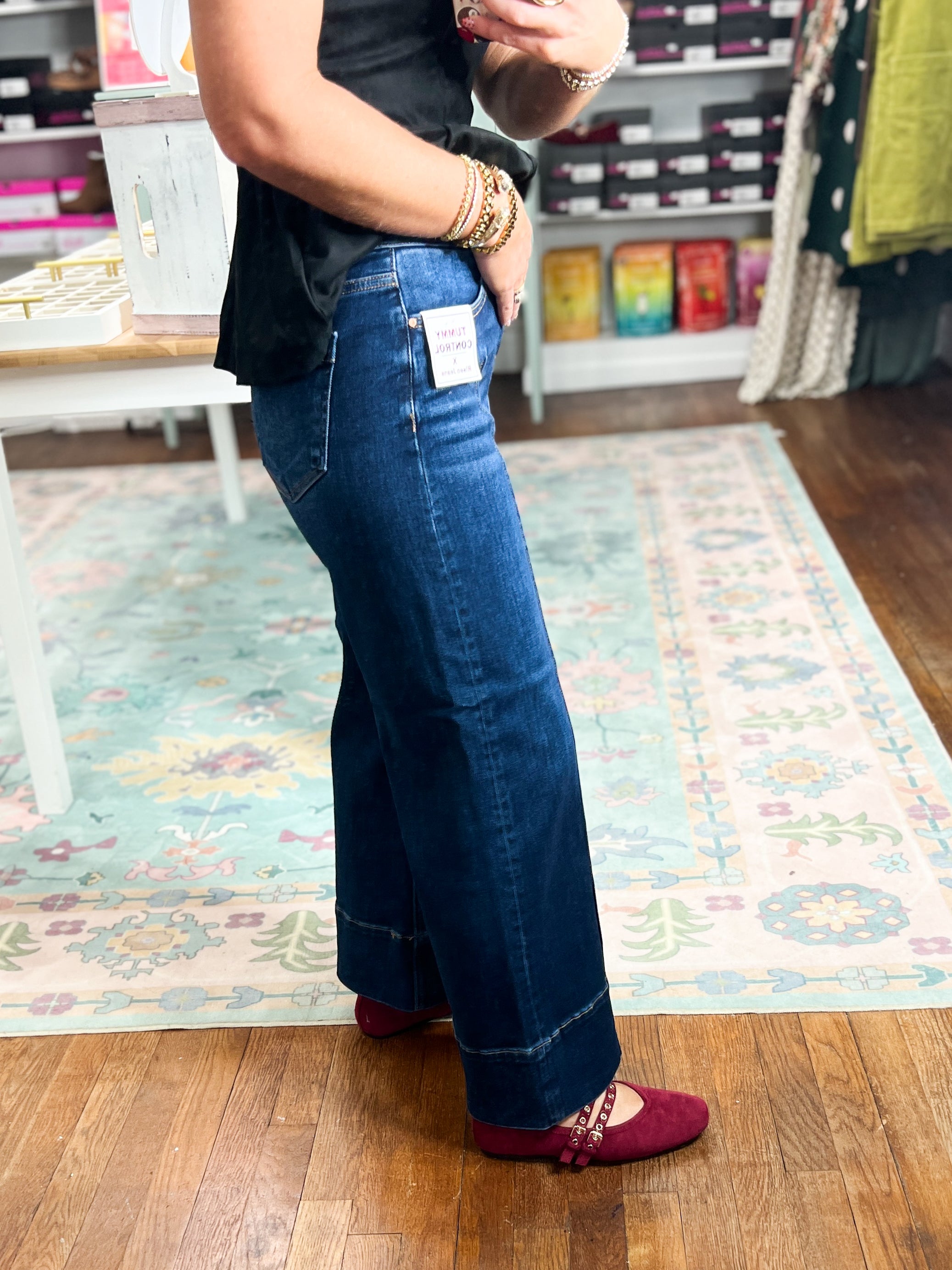Deep blue mid-rise crop jeans with wide legs and pintuck front