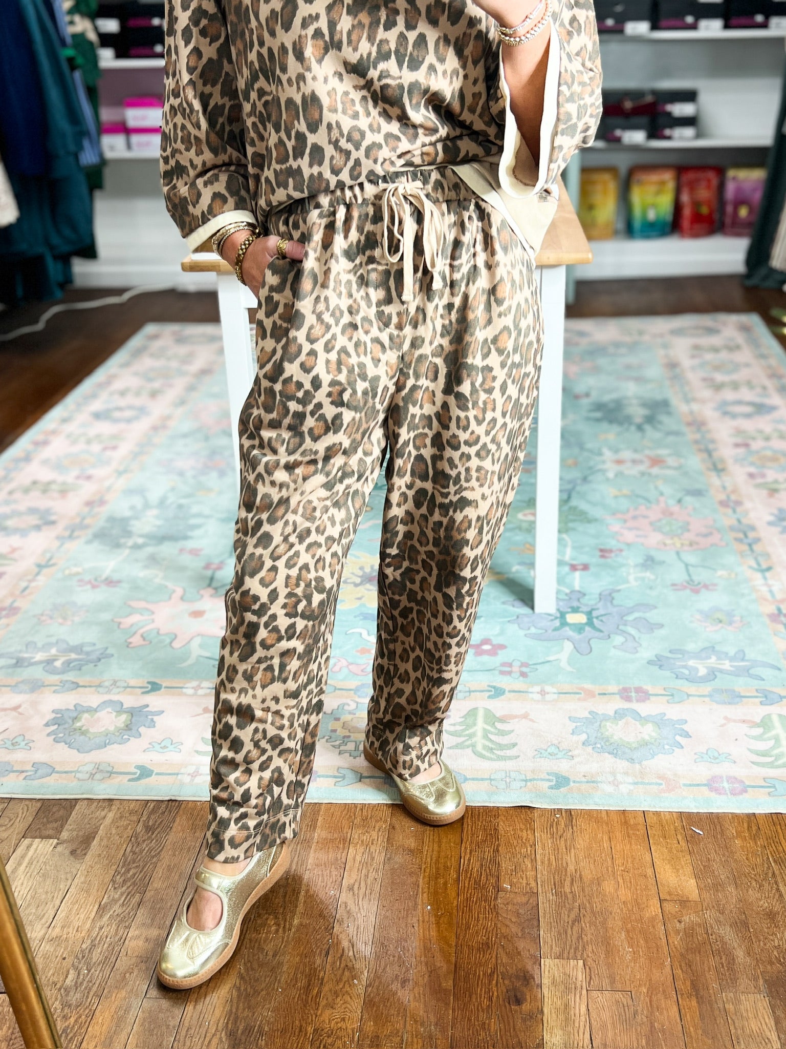 Animal-print ankle-length pants with a gathered drawstring waistband.
