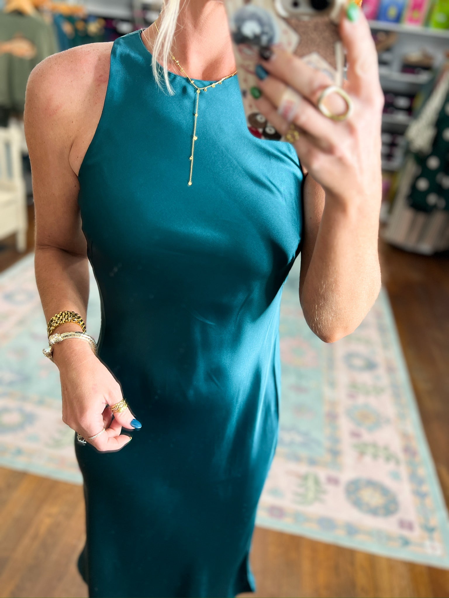 Dark teal satin midi dress close-up of neckline with small button placket.