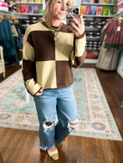 Color-block crew neck sweater in dark brown and cream with long sleeves (front close)