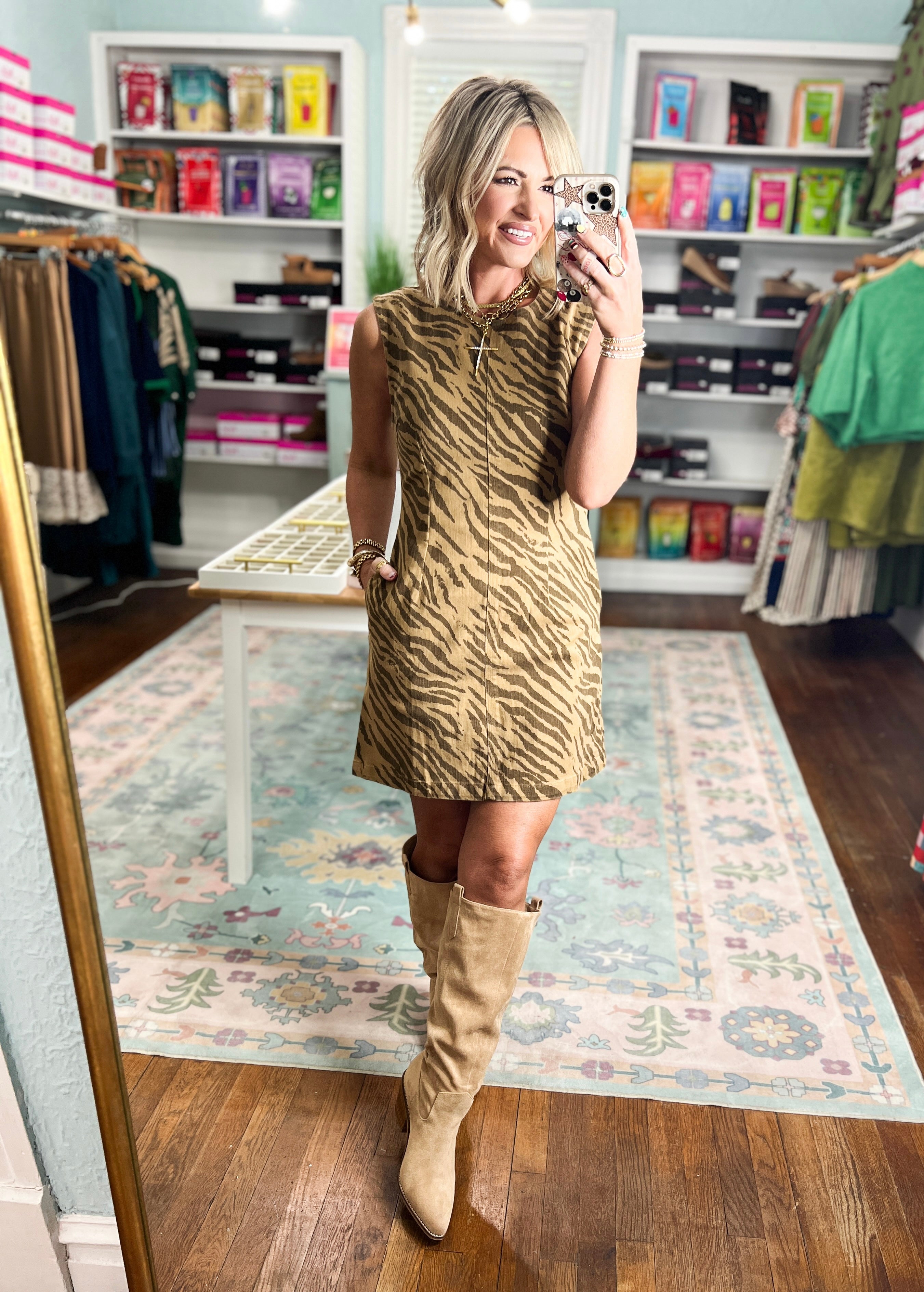 Brown tiger-print mini dress with sleeveless cut and high neckline, modeled from the front.