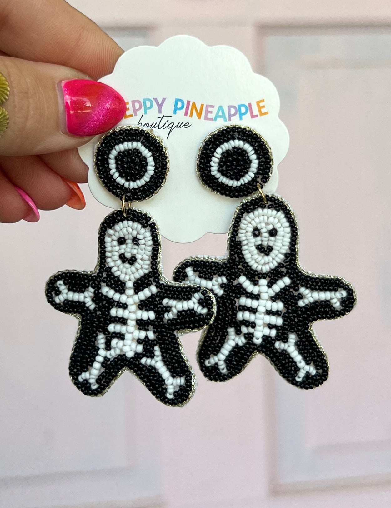 Black beaded skeleton ghost drop earrings with round eyes and detailed stitching
