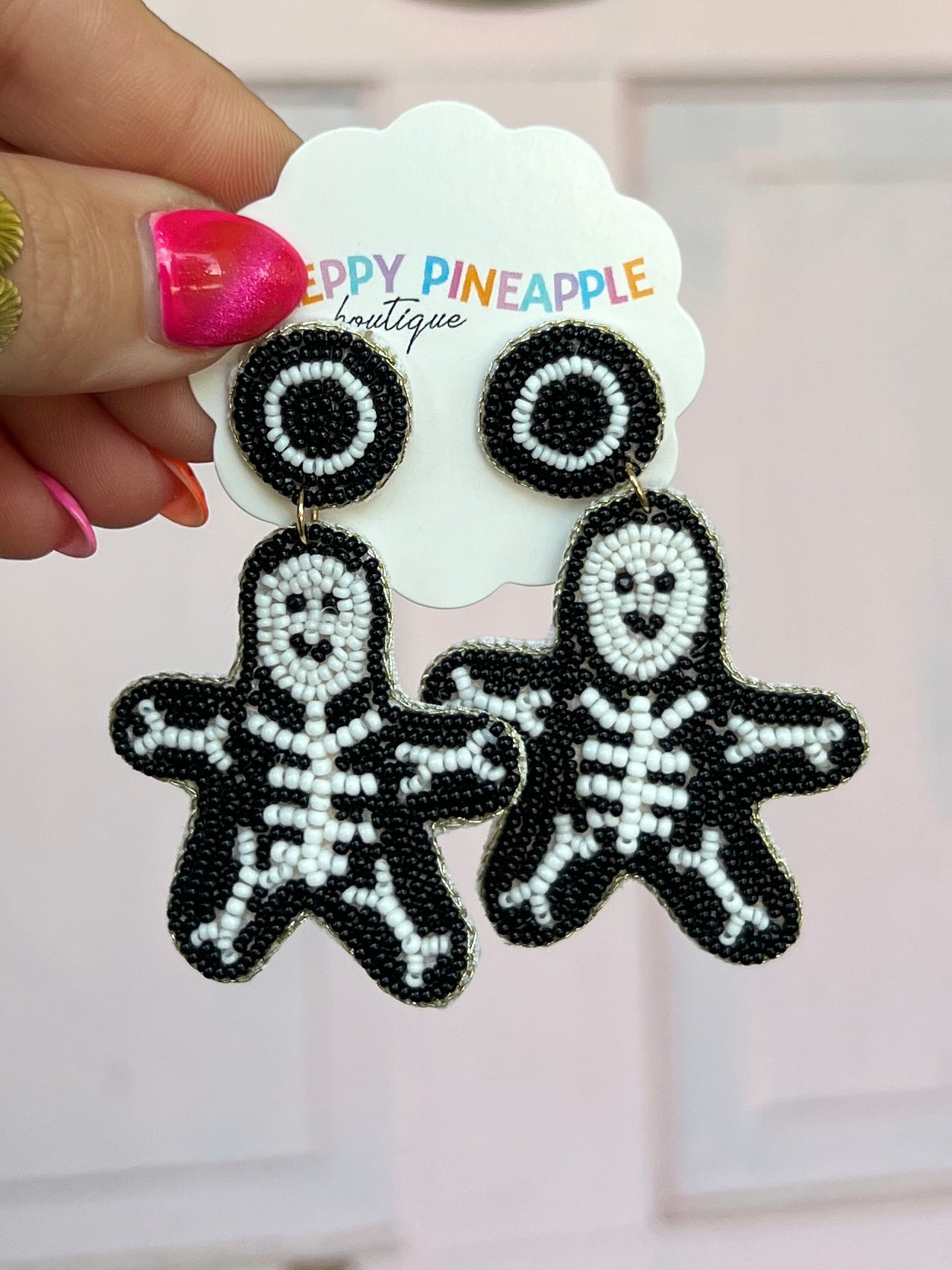Black beaded skeleton ghost drop earrings with round eyes and detailed stitching