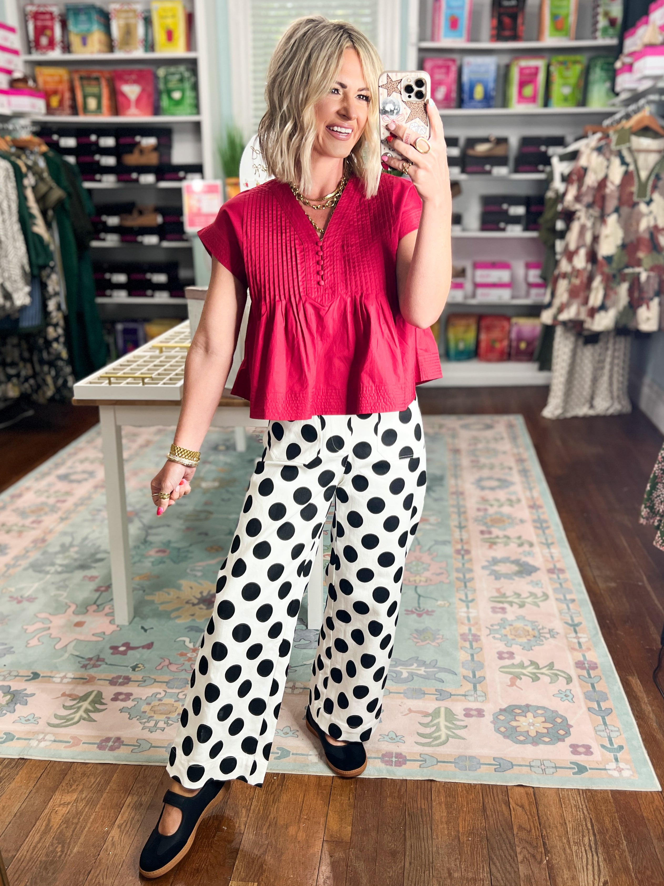 Off-white wide-leg denim pants with large black polka dots, full-length view