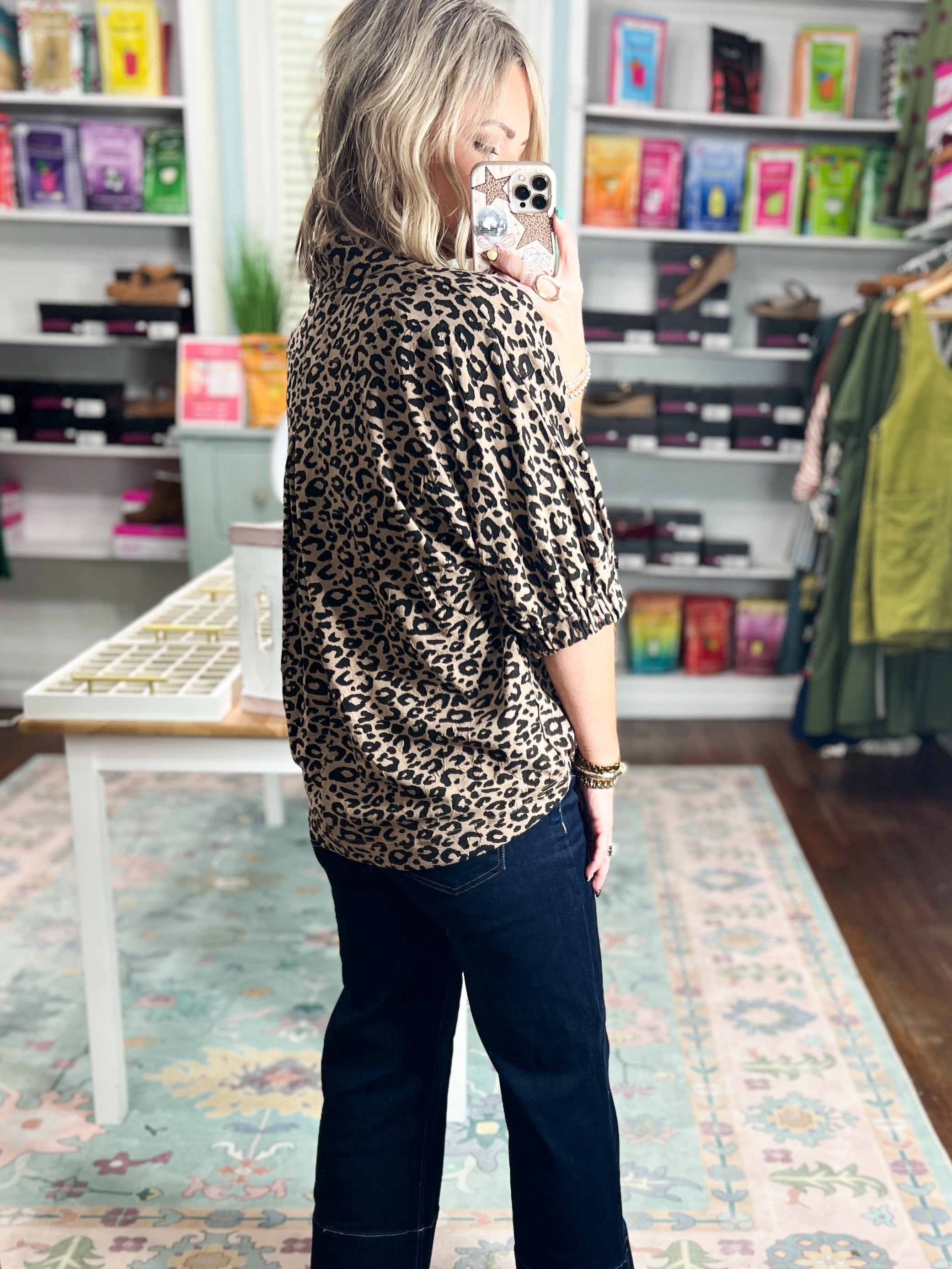 Back view of taupe leopard print pleated blouse top with V-neckline