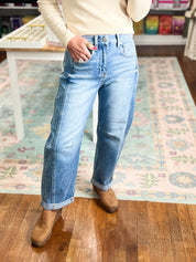 Medium-wash high-rise crop barrel jeans with cuffed hem and belt loops