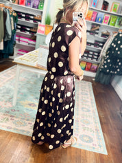Brown polka-dot bubble top with short sleeves, gathered waist and flared hem