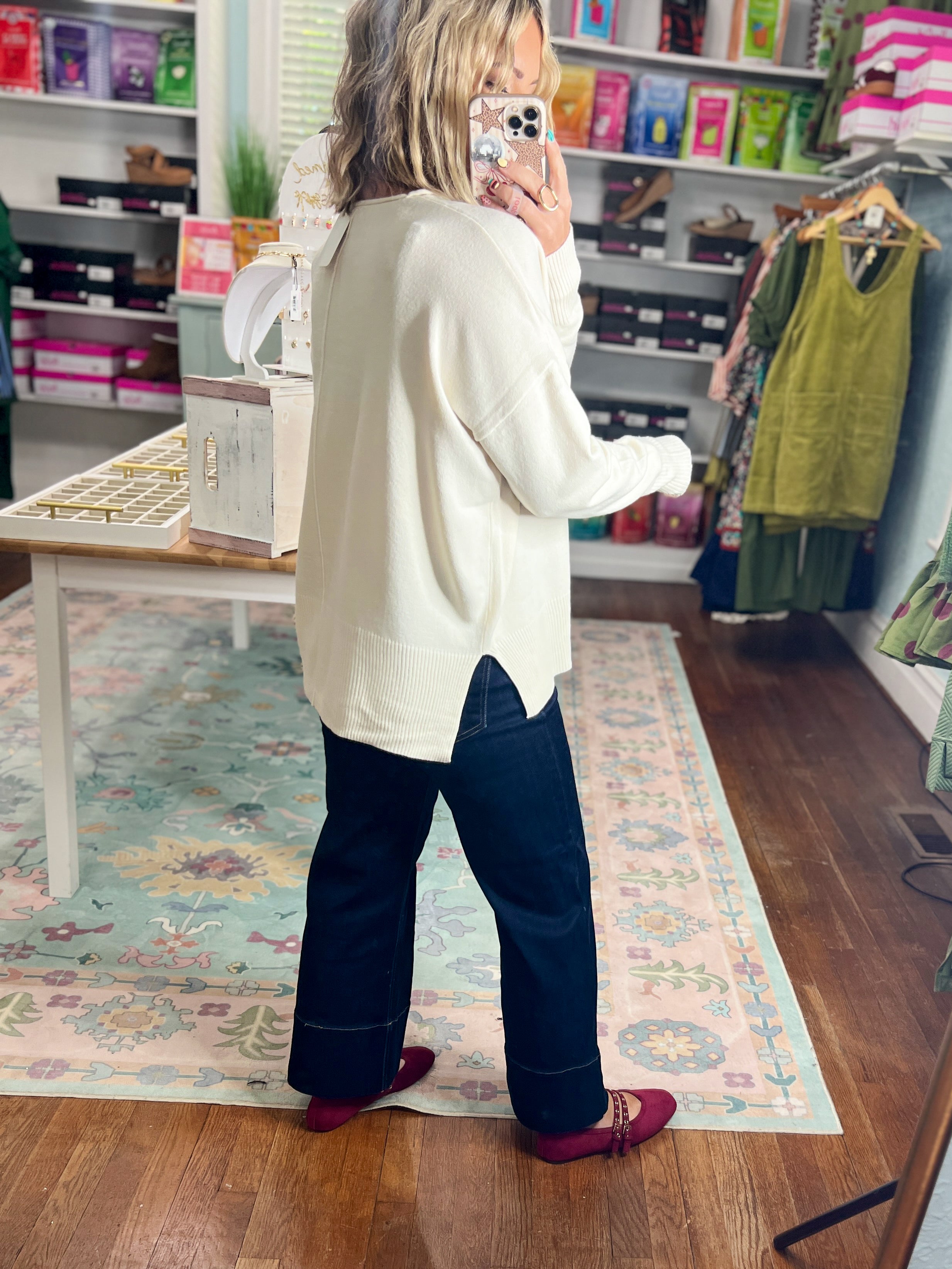 Cream roll-neck seam-detail sweater, side/back view with long sleeves