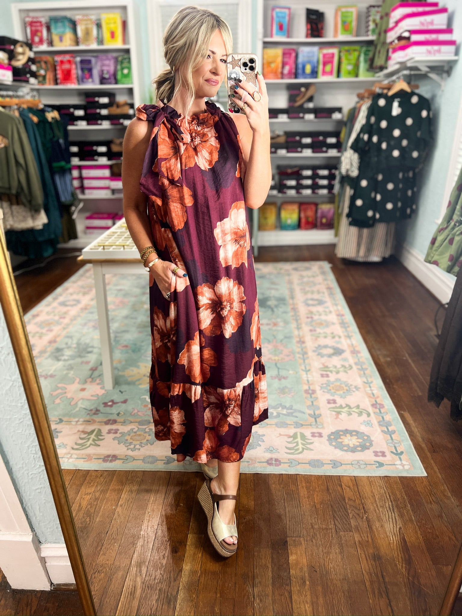 Sleeveless midi dress in deep burgundy with large floral print and bow tie neckline