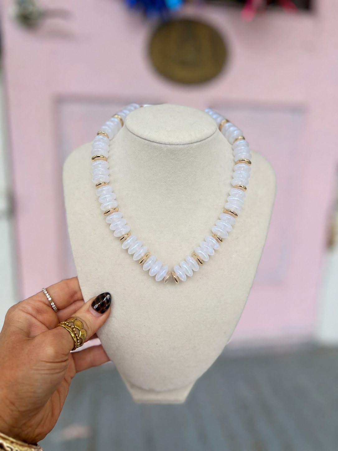 White marbleized rondelle stone bead necklace with gold-tone clasp and accents
