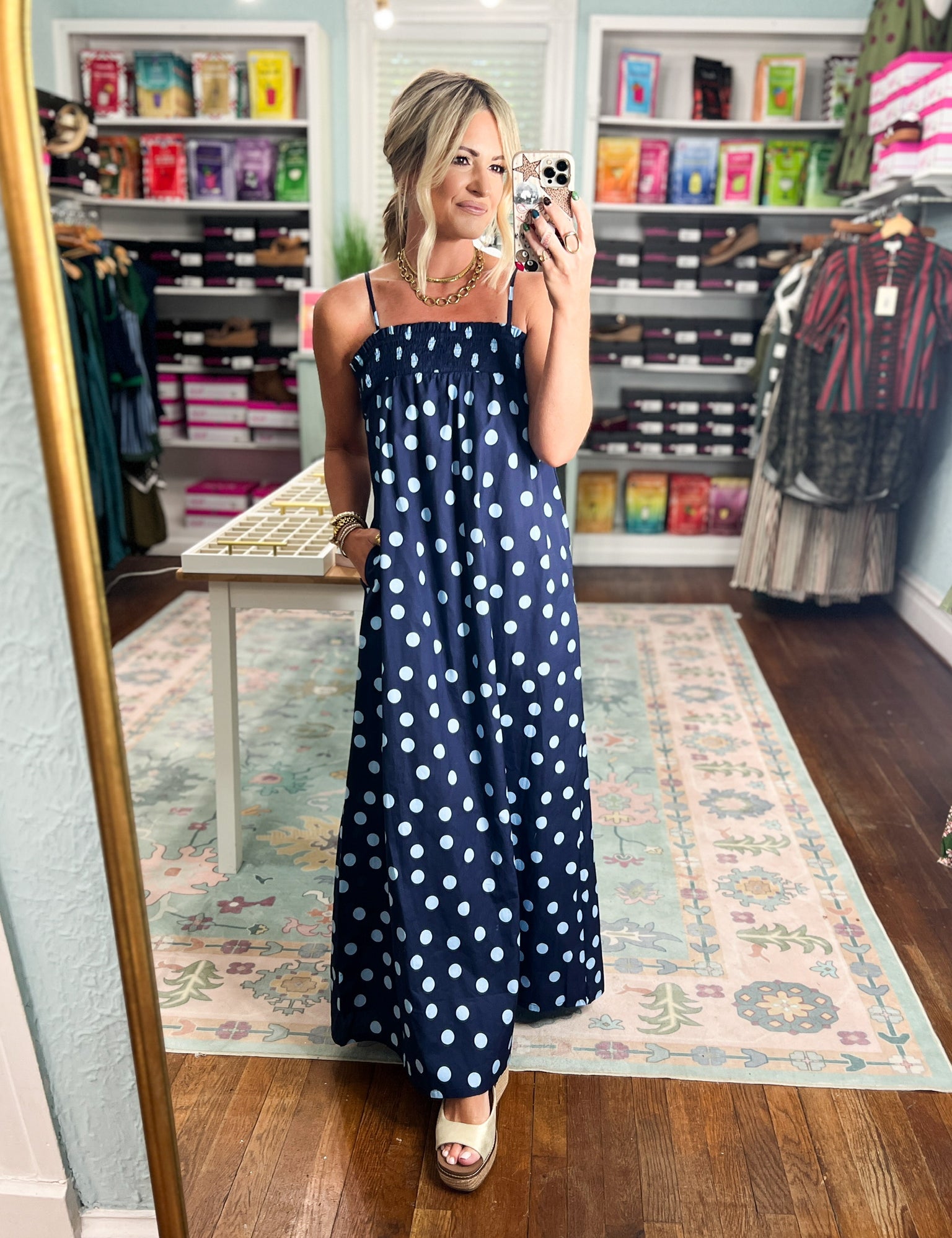Navy polka-dot maxi dress with thin spaghetti straps and long skirt