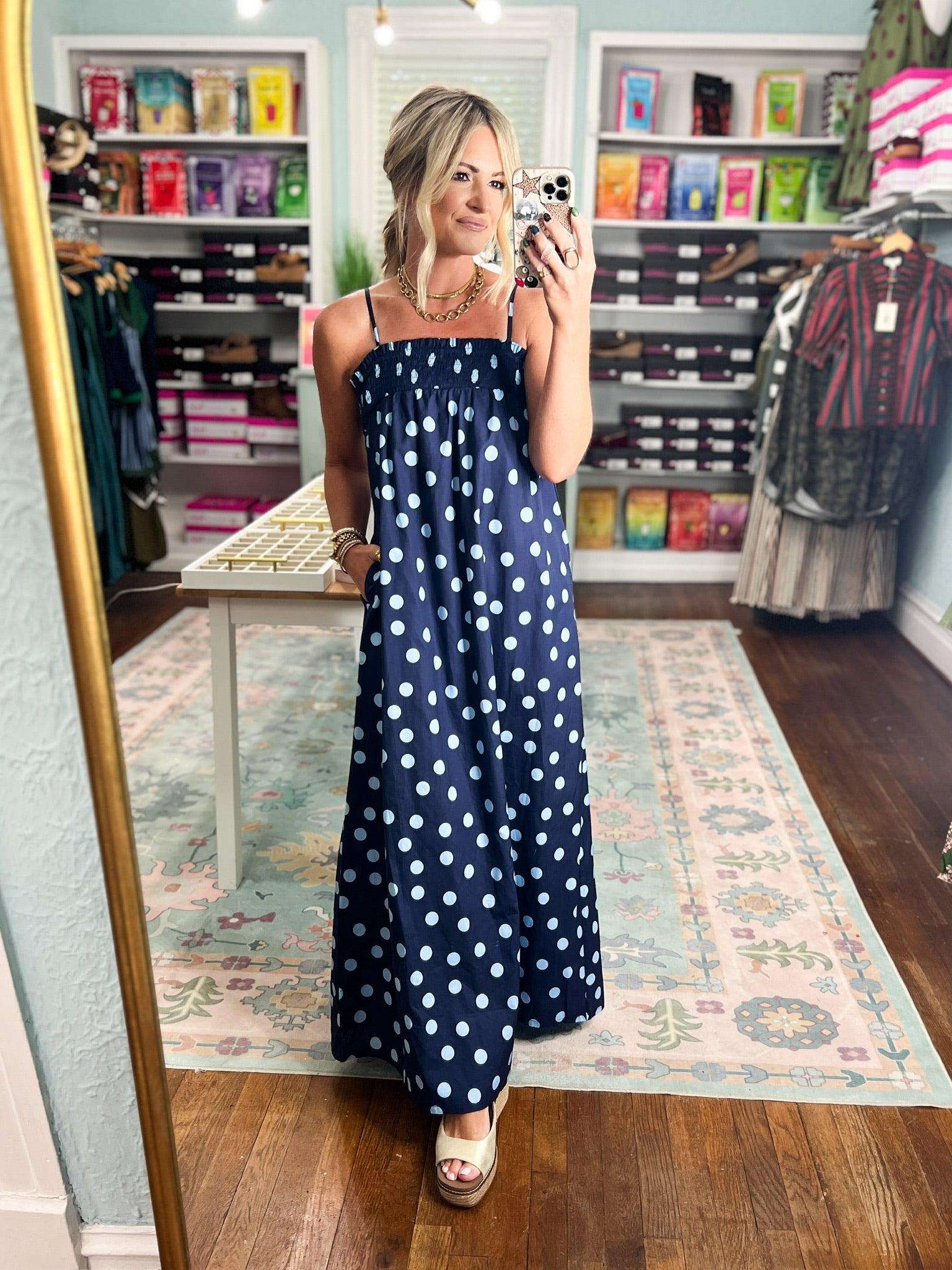 Navy polka-dot maxi dress with thin spaghetti straps and long skirt