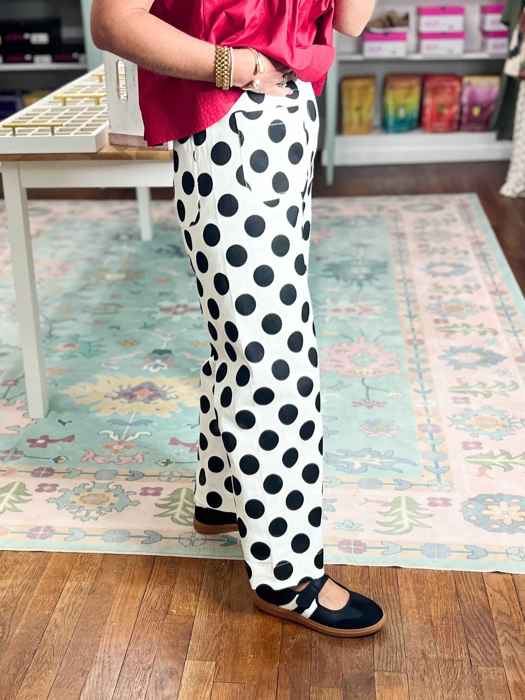 Off-white wide-leg denim pants with black polka dots, side view