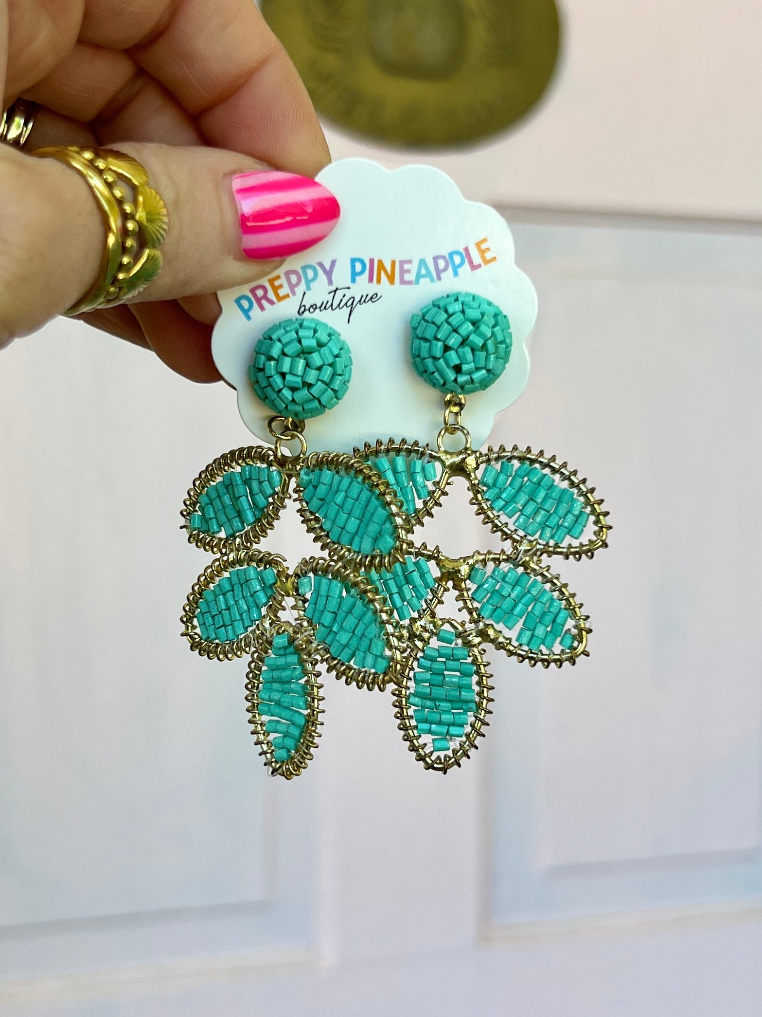 Turquoise beaded leaf dangle earrings with gold-tone hooks, layered leaf drops