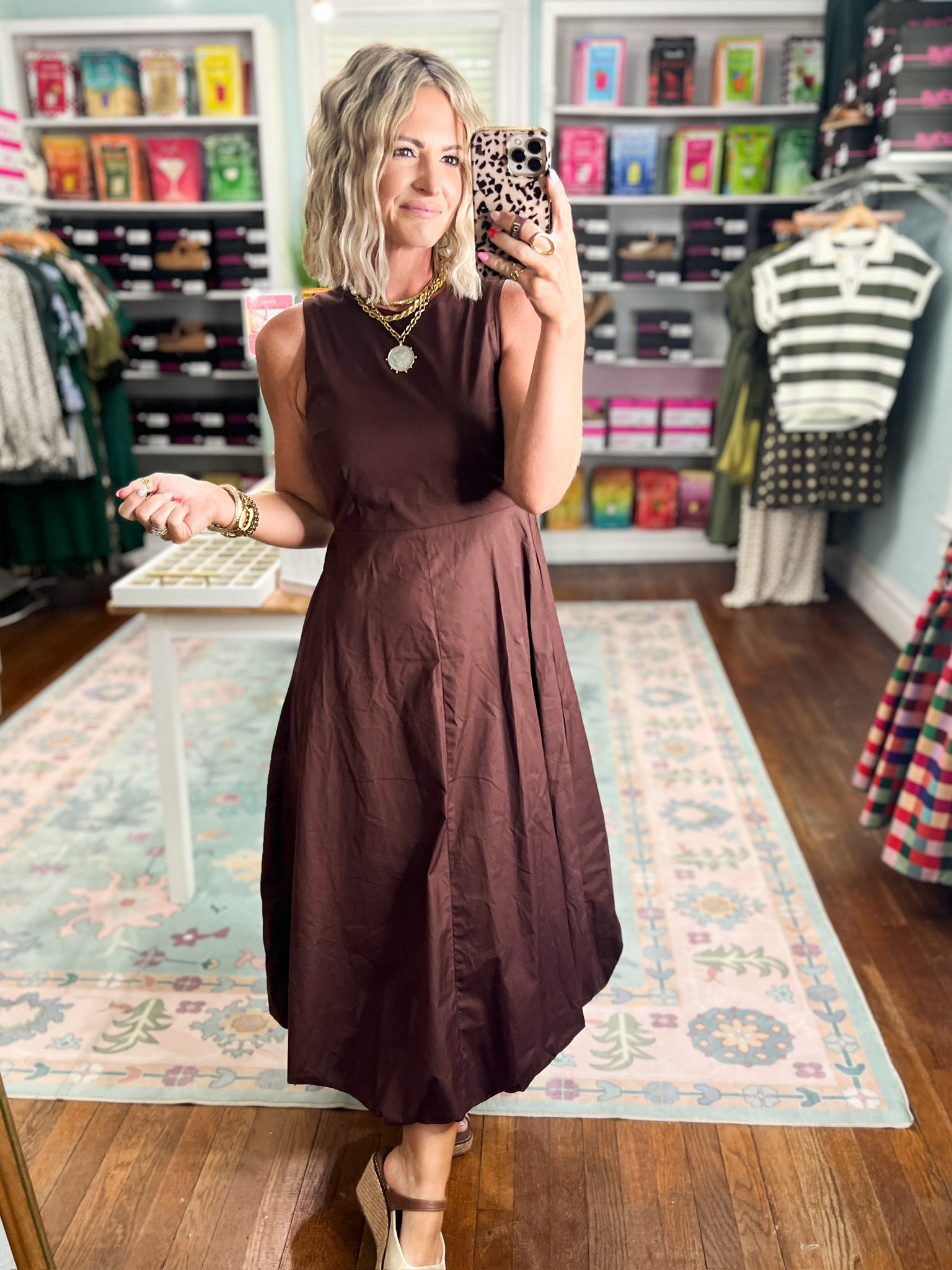 Brown sleeveless midi dress with fitted bodice and draped polka-dot waist panel