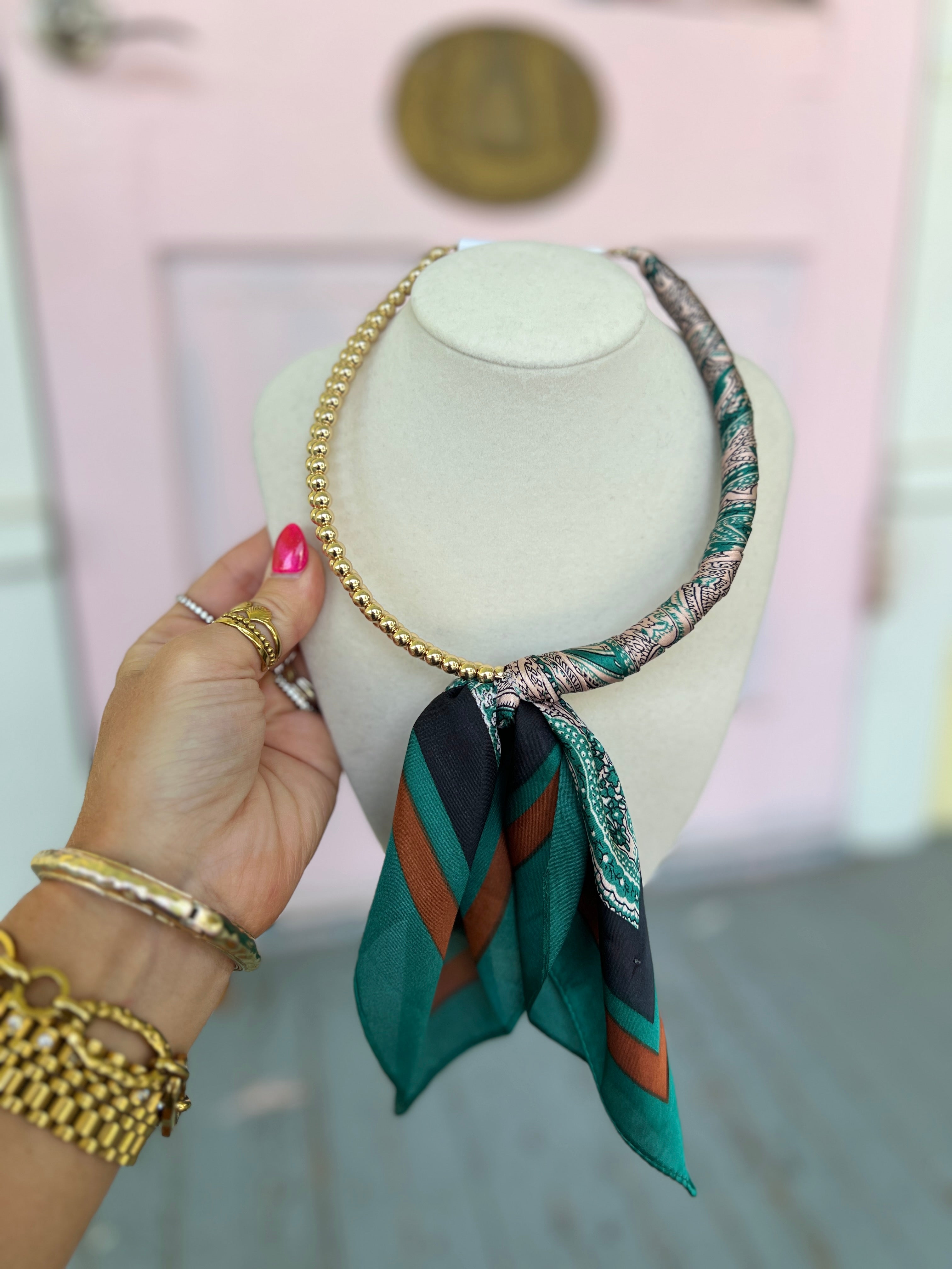 Teal scarf ball necklace with gold chain and patterned teal scarf drape