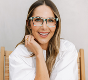 Orchid blossom and navy eyeglass frames with clear lenses, worn front view