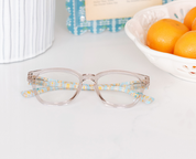 Light gray eyeglasses with clear lenses and multicolor patterned temple arms