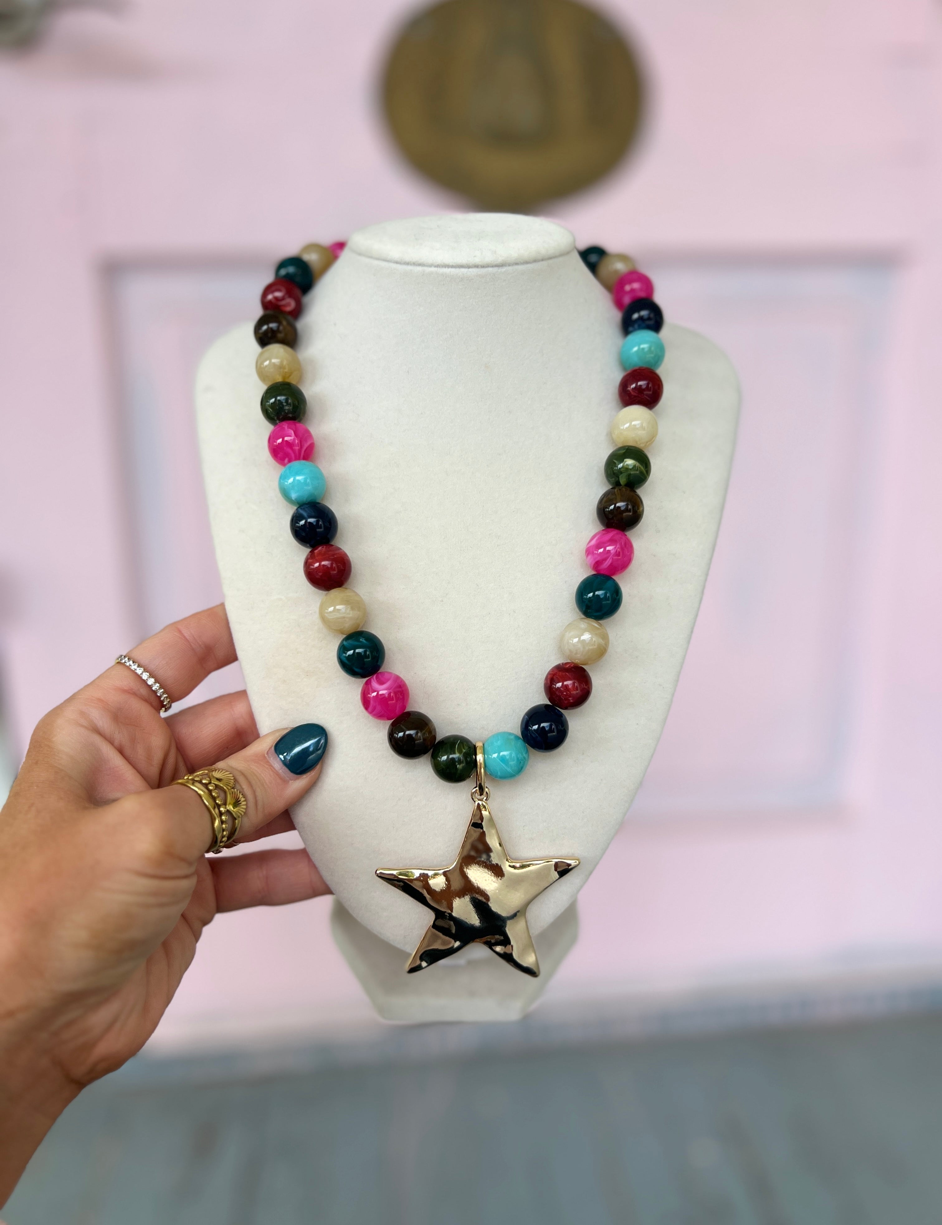 Multicolor beaded ball necklace with large gold star pendant