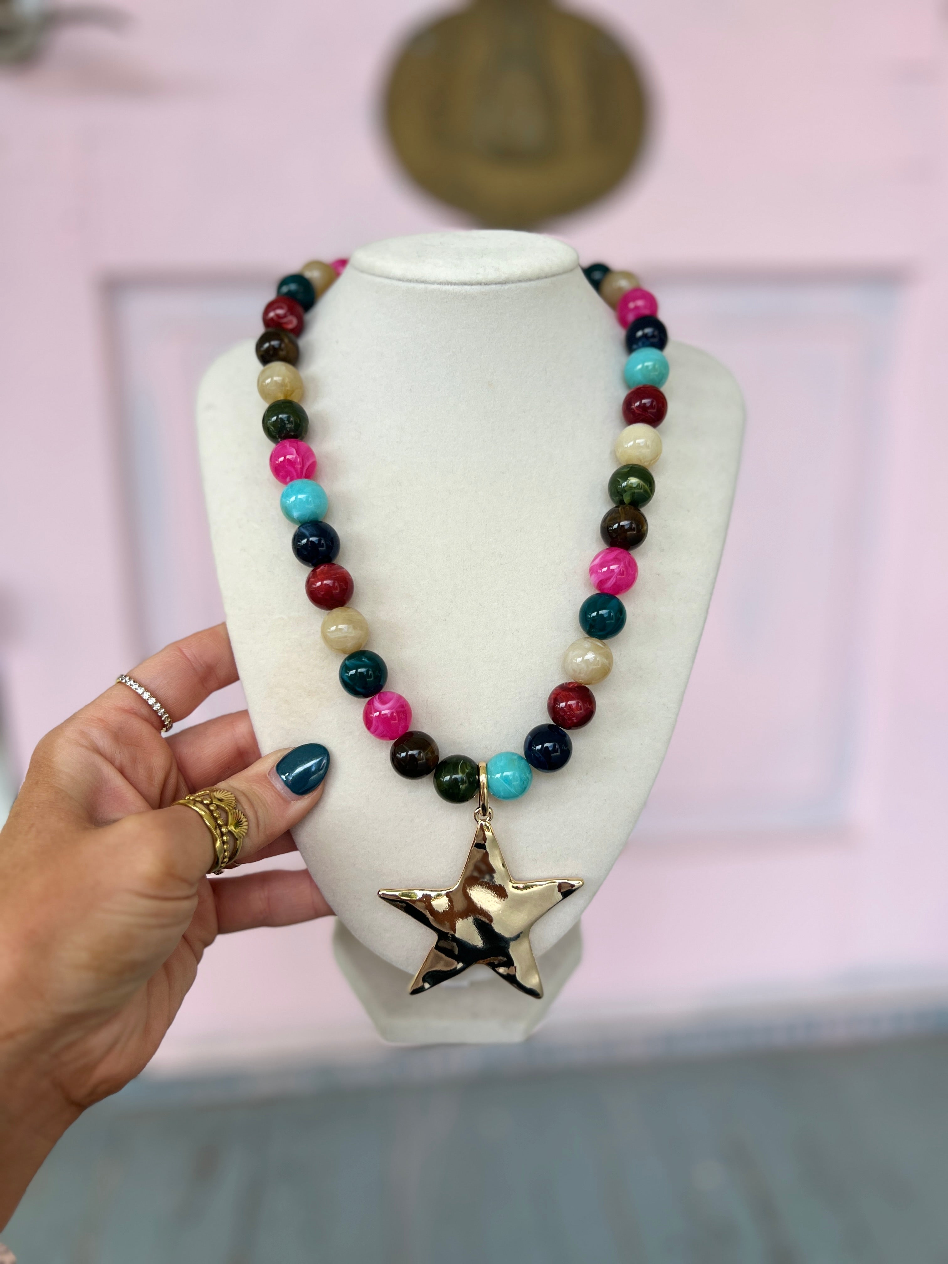 Multicolor beaded ball necklace with large gold star pendant