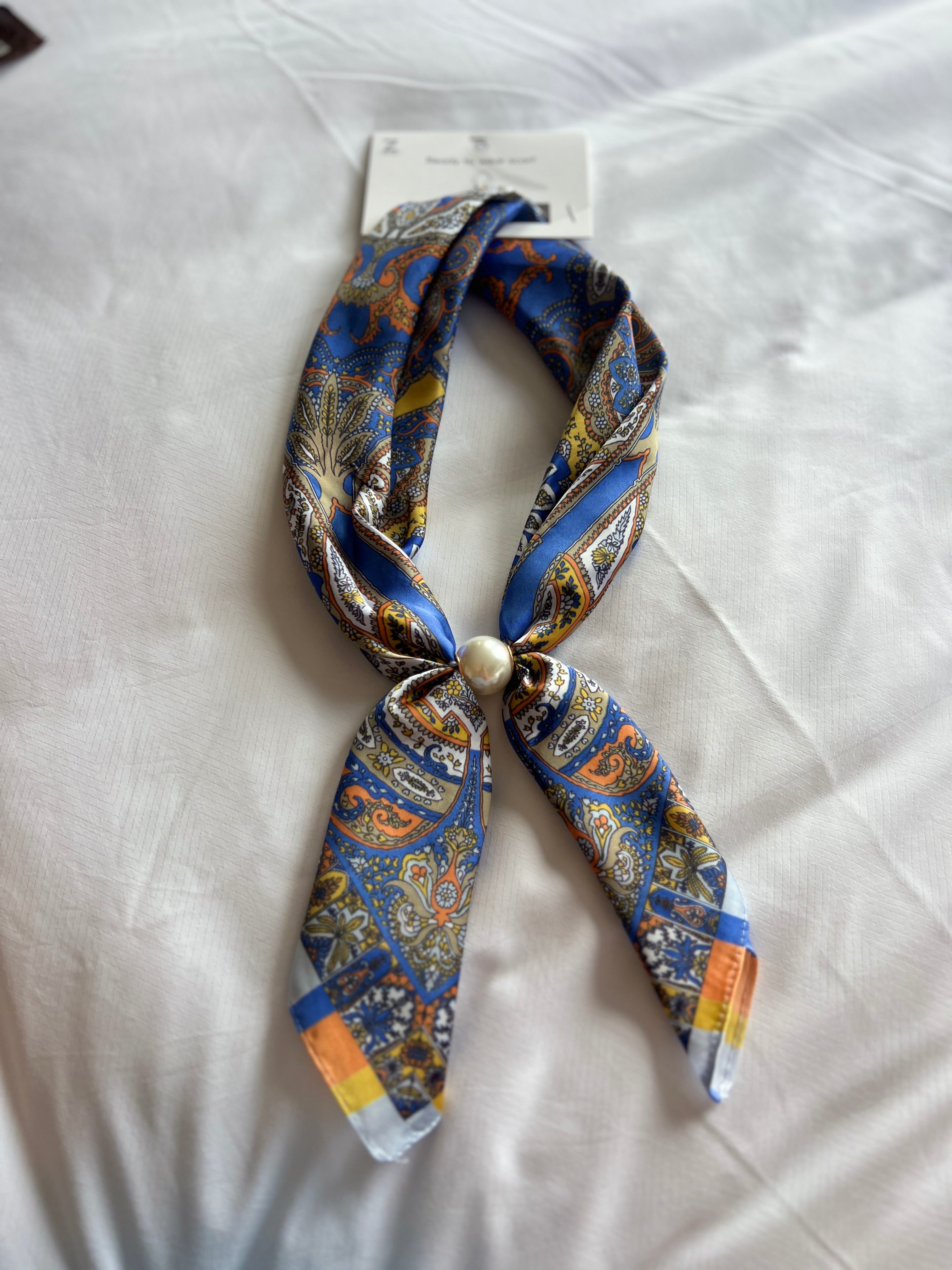 Blue paisley scarf necklace with pearl charm, tied bow at center