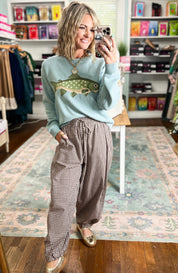 Sage crewneck sweater with a fish graphic, shown with ribbed cuffs and hem